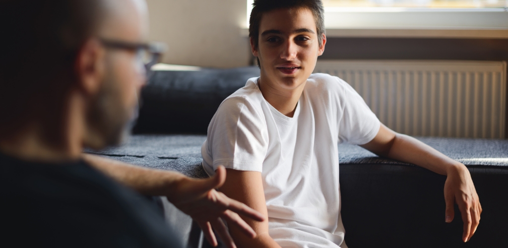 teen boy sitting on couch